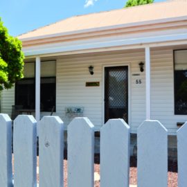 Front of Walwa Cottage showing front door and windows and the beautiful white picket fence
